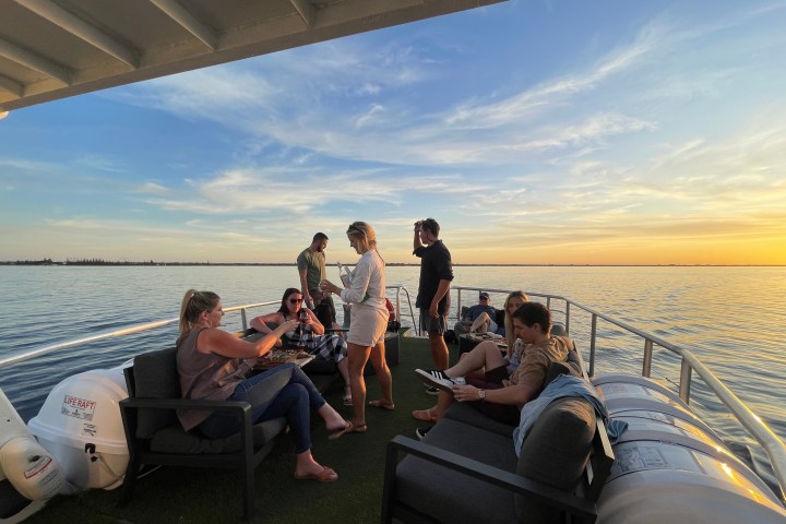 a group of people sitting at a dock