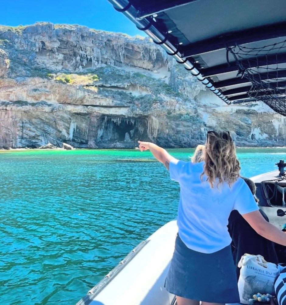 a woman standing next to a body of water