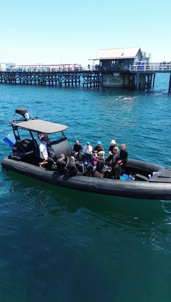 a group of people in a boat on a body of water